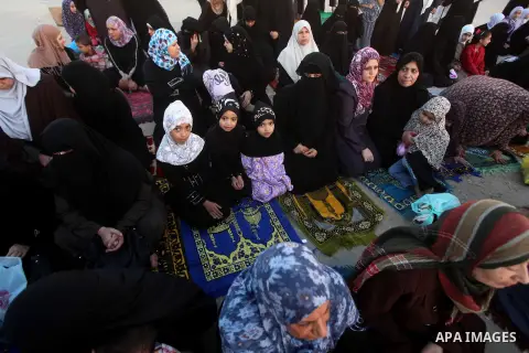 Palestinians listen to a speech by Palestinian Prime Minister in gaza, Ismail Haniya during a mass prayer on the first day of the Muslim holiday of Eid al-Adha, at al-Nusairat, in the central Gaza Strip, on October 26, 2...