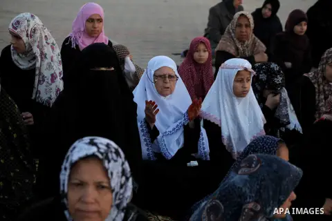 Palestinians listen to a speech by Palestinian Prime Minister in gaza, Ismail Haniya during a mass prayer on the first day of the Muslim holiday of Eid al-Adha, at al-Nusairat, in the central Gaza Strip, on October 26, 2...
