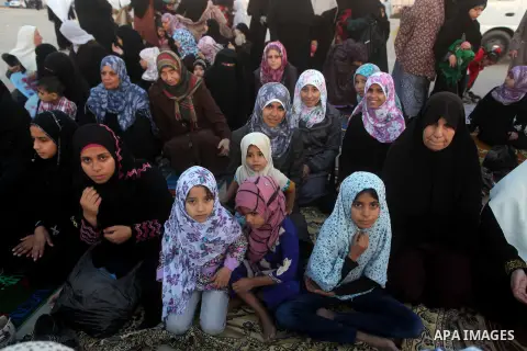Palestinians listen to a speech by Palestinian Prime Minister in gaza, Ismail Haniya during a mass prayer on the first day of the Muslim holiday of Eid al-Adha, at al-Nusairat, in the central Gaza Strip, on October 26, 2...