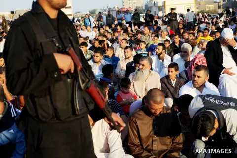 Hamas security forces stand guard during a mass prayer on the first day of the Muslim holiday of Eid al-Adha, at al-Nusairat, in the central Gaza Strip, on October 26, 2012. Muslims around the world celebrate Eid al-Adha...