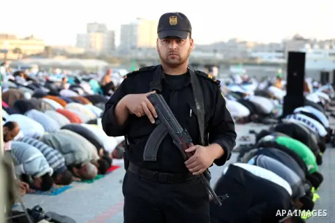 Hamas security forces stand guard during a mass prayer on the first day of the Muslim holiday of Eid al-Adha, at al-Nusairat, in the central Gaza Strip, on October 26, 2012. Muslims around the world celebrate Eid al-Adha...