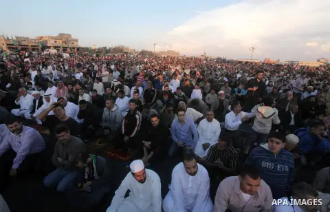 Palestinians listen to a speech by Palestinian Prime Minister in gaza, Ismail Haniya during a mass prayer on the first day of the Muslim holiday of Eid al-Adha, at al-Nusairat, in the central Gaza Strip, on October 26, 2...