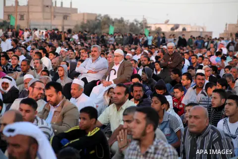 Palestinians listen to a speech by Palestinian Prime Minister in gaza, Ismail Haniya during a mass prayer on the first day of the Muslim holiday of Eid al-Adha, at al-Nusairat, in the central Gaza Strip, on October 26, 2...