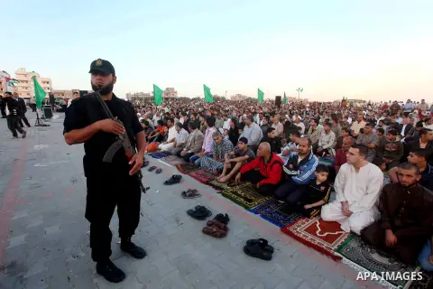 Hamas security forces stand guard during a mass prayer on the first day of the Muslim holiday of Eid al-Adha, at al-Nusairat, in the central Gaza Strip, on October 26, 2012. Muslims around the world celebrate Eid al-Adha...