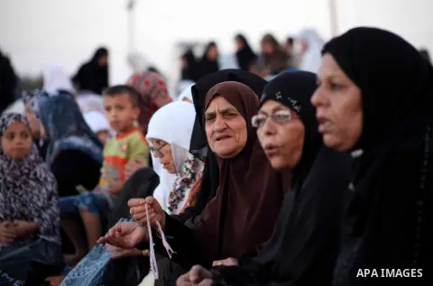 Palestinians listen to a speech by Palestinian Prime Minister in gaza, Ismail Haniya during a mass prayer on the first day of the Muslim holiday of Eid al-Adha, at al-Nusairat, in the central Gaza Strip, on October 26, 2...