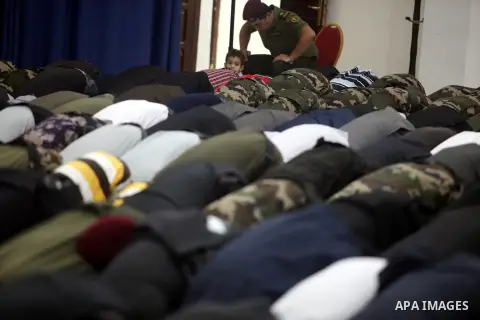 Palestinian president Mahmud Abbas, and other Palestinian officials perform the early morning Eid al-Adha prayer at the Palestinian Authority headquarters in the West Bank city of Ramallah on October 26, 2012. Muslims wo...