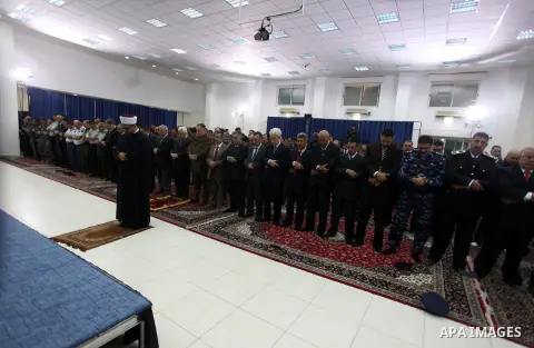 Palestinian president Mahmud Abbas, and other Palestinian officials perform the early morning Eid al-Adha prayer at the Palestinian Authority headquarters in the West Bank city of Ramallah on October 26, 2012. Muslims wo...