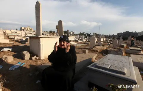 Palestinians visit the graves of relatives at a cemetery in Gaza city on the first day of Eid al-Adha, on October 26, 2012 as Muslims worldwide commemorate Eid al-Adha, or the Feast of the Sacrifice, marking the end of t...