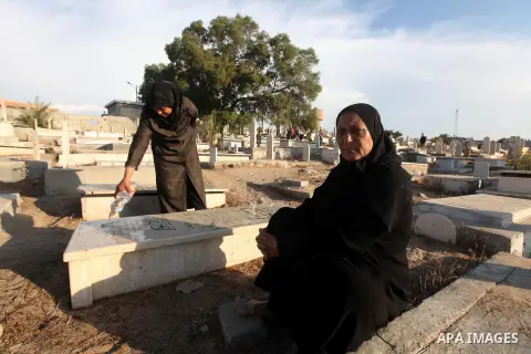 Palestinians visit the graves of relatives at a cemetery in Gaza city on the first day of Eid al-Adha, on October 26, 2012 as Muslims worldwide commemorate Eid al-Adha, or the Feast of the Sacrifice, marking the end of t...