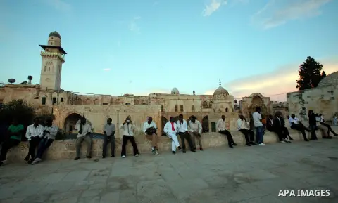 Foreign Muslim worshippers take pictures in front of the Dome of the Rock in Jerusalem's Old city in Jerusalem's old city on the first day of Eid al-Adha on October 26, 2012 as Muslims worldwide commemorate Eid al-Adha,...