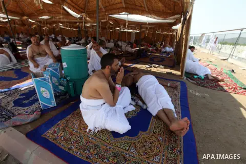 A Muslim pilgrim prays while others rests on Mount Mercy on the plains of Arafat during the peak of the annual haj pilgrimage near the holy city of Mecca October 26, 2012. Nearly 3 million Muslim pilgrims started the fir...