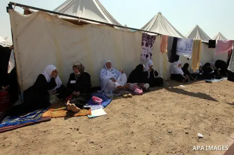 Muslim pilgrims rest on Mount Mercy on the plains of Arafat during the peak of the annual haj pilgrimage near the holy city of Mecca October 26, 2012. Nearly 3 million Muslim pilgrims started the first phase of the annua...