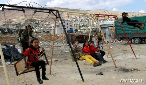 Palestinian children enjoy a ride at an amusement park during the second day of Eid al-Adha in the West Bank city of Nablus, oct 27, 2012. Muslims around the world celebrate Eid-al-Adha, marking the end of the haj, by sl...