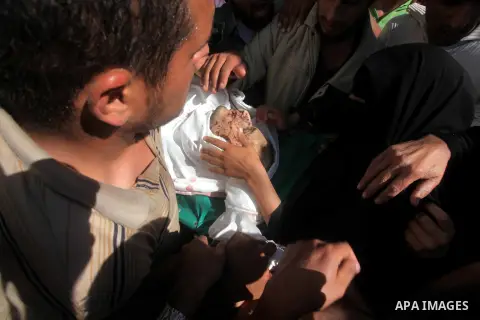 Palestinians carry the body of Suleiman al-Qarra during his funeral in Khanions, Southern Gaza Strip, on October 28, 2012. Israel killed the Hamas gunman it accused of preparing to fire a rocket from the Gaza Strip . Pho...