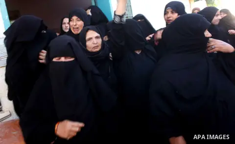 Relatives of Palestinian Suleiman al-Qarra mourn during his funeral in Khanions, in the Southern Gaza Strip, on October 28, 2012. Israel killed the Hamas gunman it accused of preparing to fire a rocket from the Gaza Stri...