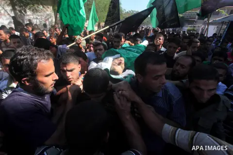 Palestinians carry the body of Suleiman al-Qarra during his funeral in Khanions, Southern Gaza Strip, on October 28, 2012. Israel killed the Hamas gunman it accused of preparing to fire a rocket from the Gaza Strip . Pho...