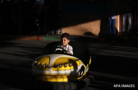 Palestinians enjoy themselves at an amusement park in Gaza City as the Muslim world celebrates the third day of the Eid al-Adha holiday on October 28, 2012. Eid al-Adha or "Feast of the Sacrifice" marks the end of the an...