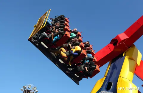 Palestinians enjoy themselves at an amusement park in Gaza City as the Muslim world celebrates the third day of the Eid al-Adha holiday on October 28, 2012. Eid al-Adha or "Feast of the Sacrifice" marks the end of the an...
