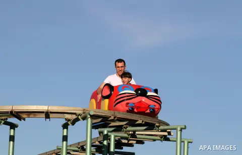 Palestinians enjoy themselves at an amusement park in Gaza City as the Muslim world celebrates the third day of the Eid al-Adha holiday on October 28, 2012. Eid al-Adha or "Feast of the Sacrifice" marks the end of the an...