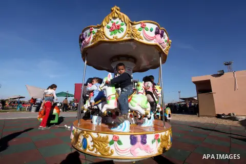Palestinians enjoy themselves at an amusement park in Gaza City as the Muslim world celebrates the third day of the Eid al-Adha holiday on October 28, 2012. Eid al-Adha or "Feast of the Sacrifice" marks the end of the an...