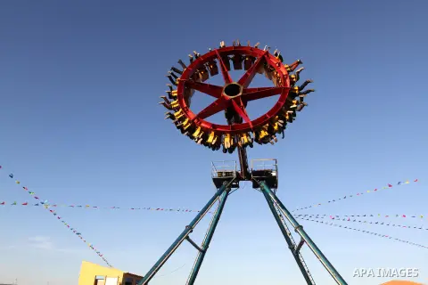 Palestinians enjoy themselves at an amusement park in Gaza City as the Muslim world celebrates the third day of the Eid al-Adha holiday on October 28, 2012. Eid al-Adha or "Feast of the Sacrifice" marks the end of the an...