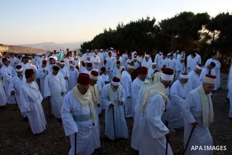 Members of the ancient Samaritan community, wrapped in a prayer shawl participate in the pilgrimage for the holy day of the Tabernacles or Sukkot at the religion's holiest site on the top of Mount Gerizim near the West B...