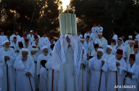 Members of the ancient Samaritan community, wrapped in a prayer shawl participate in the pilgrimage for the holy day of the Tabernacles or Sukkot at the religion's holiest site on the top of Mount Gerizim near the West B...