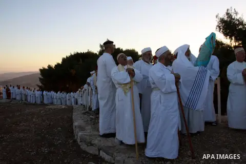 Members of the ancient Samaritan community, wrapped in a prayer shawl participate in the pilgrimage for the holy day of the Tabernacles or Sukkot at the religion's holiest site on the top of Mount Gerizim near the West B...