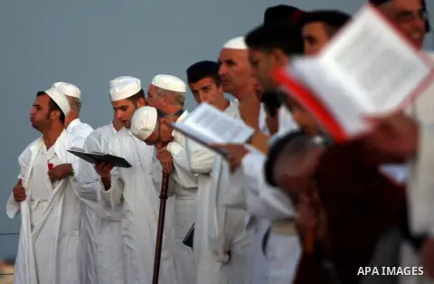 Members of the ancient Samaritan community, wrapped in a prayer shawl participate in the pilgrimage for the holy day of the Tabernacles or Sukkot at the religion's holiest site on the top of Mount Gerizim near the West B...