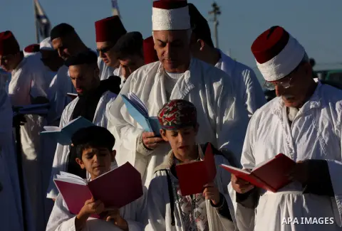 Members of the ancient Samaritan community, wrapped in a prayer shawl participate in the pilgrimage for the holy day of the Tabernacles or Sukkot at the religion's holiest site on the top of Mount Gerizim near the West B...
