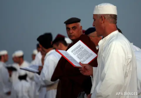 Members of the ancient Samaritan community, wrapped in a prayer shawl participate in the pilgrimage for the holy day of the Tabernacles or Sukkot at the religion's holiest site on the top of Mount Gerizim near the West B...