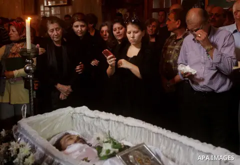 Palestinian relatives of Christian Hossam Al-Tawil mourn on his body during his funeral at the Church of Saint Porphyrius in Gaza city on Nov. 01, 2012. Al-Tawil passed away in Egypt after seeking medical treatment in th...