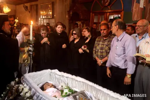 Palestinian relatives of Christian Hossam Al-Tawil mourn on his body during his funeral at the Church of Saint Porphyrius in Gaza city on Nov. 01, 2012. Al-Tawil passed away in Egypt after seeking medical treatment in th...
