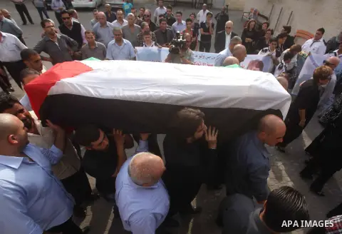 Palestinians carry the body of Christian Hossam Al-Tawil during his funeral at the Church of Saint Porphyrius in Gaza city on Nov. 01, 2012. Al-Tawil passed away in Egypt after seeking medical treatment in the country. H...