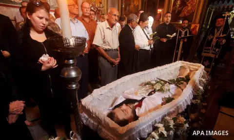 Palestinian relatives of Christian Hossam Al-Tawil mourn on his body during his funeral at the Church of Saint Porphyrius in Gaza city on Nov. 01, 2012. Al-Tawil passed away in Egypt after seeking medical treatment in th...