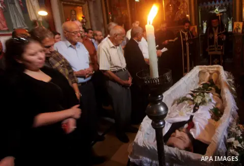 Palestinian relatives of Christian Hossam Al-Tawil mourn on his body during his funeral at the Church of Saint Porphyrius in Gaza city on Nov. 01, 2012. Al-Tawil passed away in Egypt after seeking medical treatment in th...
