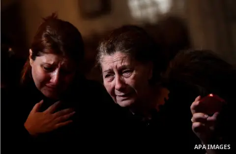 Palestinian relatives of Christian Hossam Al-Tawil mourn on his body during his funeral at the Church of Saint Porphyrius in Gaza city on Nov. 01, 2012. Al-Tawil passed away in Egypt after seeking medical treatment in th...