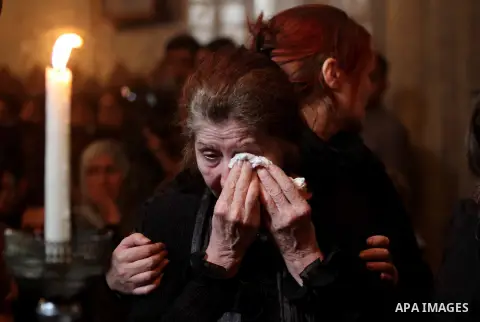 Palestinian relatives of Christian Hossam Al-Tawil mourn on his body during his funeral at the Church of Saint Porphyrius in Gaza city on Nov. 01, 2012. Al-Tawil passed away in Egypt after seeking medical treatment in th...