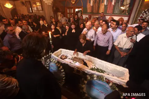 Palestinian relatives of Christian Hossam Al-Tawil mourn on his body during his funeral at the Church of Saint Porphyrius in Gaza city on Nov. 01, 2012. Al-Tawil passed away in Egypt after seeking medical treatment in th...