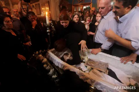 Palestinian relatives of Christian Hossam Al-Tawil mourn on his body during his funeral at the Church of Saint Porphyrius in Gaza city on Nov. 01, 2012. Al-Tawil passed away in Egypt after seeking medical treatment in th...
