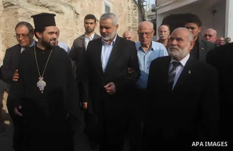 Palestinian Prime Minister in Gaza strip Ismail Haniyeh condoles the relatives of Christian Hossam Al-Tawil during his funeral at the Church of Saint Porphyrius in Gaza city on Nov. 01, 2012. Al-Tawil passed away in Egyp...