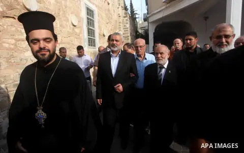 Palestinian Prime Minister in Gaza strip Ismail Haniyeh condoles the relatives of Christian Hossam Al-Tawil during his funeral at the Church of Saint Porphyrius in Gaza city on Nov. 01, 2012. Al-Tawil passed away in Egyp...
