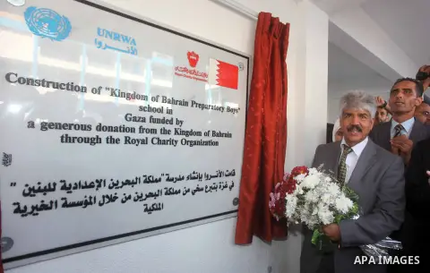 Secretary General of the Royal Charity Organization in the Kingdom of Bahrain, Mustafa al-Sayed, holds a flower bouquet as he opens a UNRWA (United Nations Relief and Works Agency) school financed by Bahrain, in Gaza Cit...