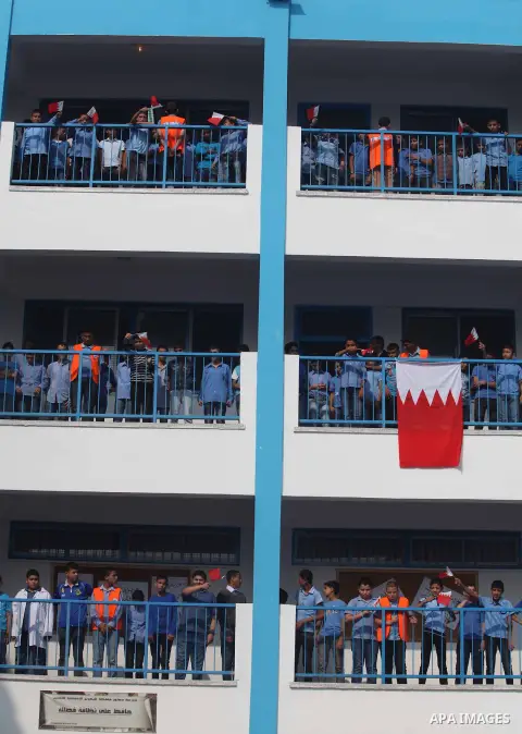Palestinian school boys hold Bahraini flags during the visit of Secretary General of the Royal Charity Organization in the Kingdom of Bahrain, Mustafa al-Sayed to a UNRWA (United Nations Relief and Works Agency) school f...