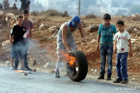 Palestinians argue with Israeli soldiers during a protest against the expansion of the nearby Jewish settlement of Halamish, in the West Bank village of Nabi Saleh near Ramallah, Friday, Nov. 2, 2012. Photo by Issam Rima...