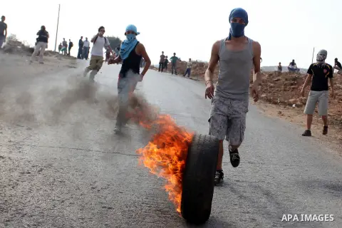 Palestinians argue with Israeli soldiers during a protest against the expansion of the nearby Jewish settlement of Halamish, in the West Bank village of Nabi Saleh near Ramallah, Friday, Nov. 2, 2012. Photo by Issam Rima...