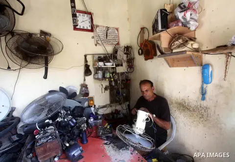 Palestinian refugee Ezat al-Sheikh Khalil repairs a fan at his workshop at the Shati Palestinian refugee camp in Gaza City on November 3, 2012. The issue of refugees is one of the thorniest elements of the Palestinian-Is...