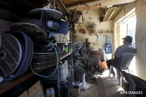 Palestinian refugee Ezat al-Sheikh Khalil repairs a fan at his workshop at the Shati Palestinian refugee camp in Gaza City on November 3, 2012. The issue of refugees is one of the thorniest elements of the Palestinian-Is...