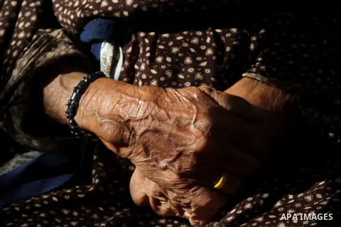 An elder Palestinian refugee woman sits next her house at the Shati Palestinian refugee camp in Gaza City on November 3, 2012. The issue of refugees is one of the thorniest elements of the Palestinian-Israeli conflict, w...
