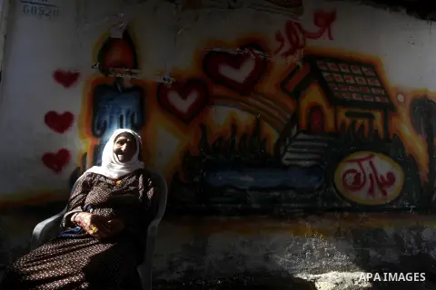 An elder Palestinian refugee woman sits next her house at the Shati Palestinian refugee camp in Gaza City on November 3, 2012. The issue of refugees is one of the thorniest elements of the Palestinian-Israeli conflict, w...